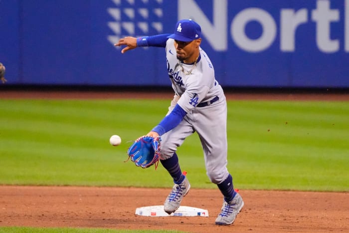 Mookie Betts puts his glove toward the ground to try to field a ball flying toward him